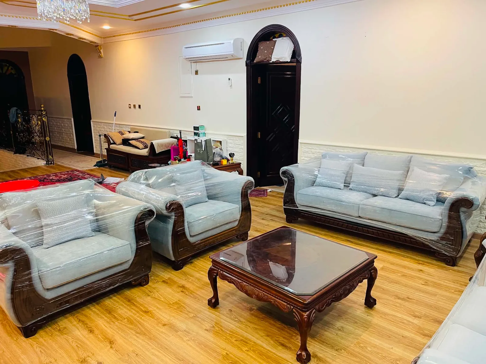 Reupholstered sofa set in pale blue, wrapped after delivery