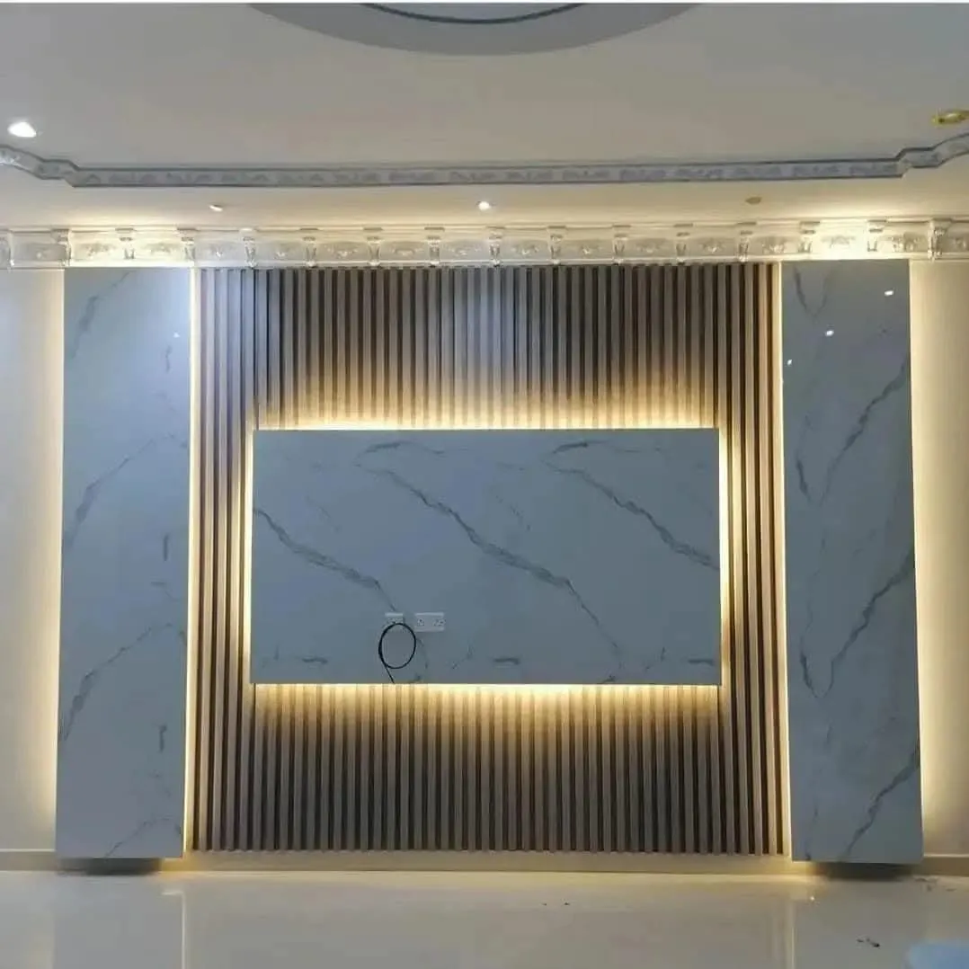Fluted slat media wall with a marble centre panel and LED backlighting